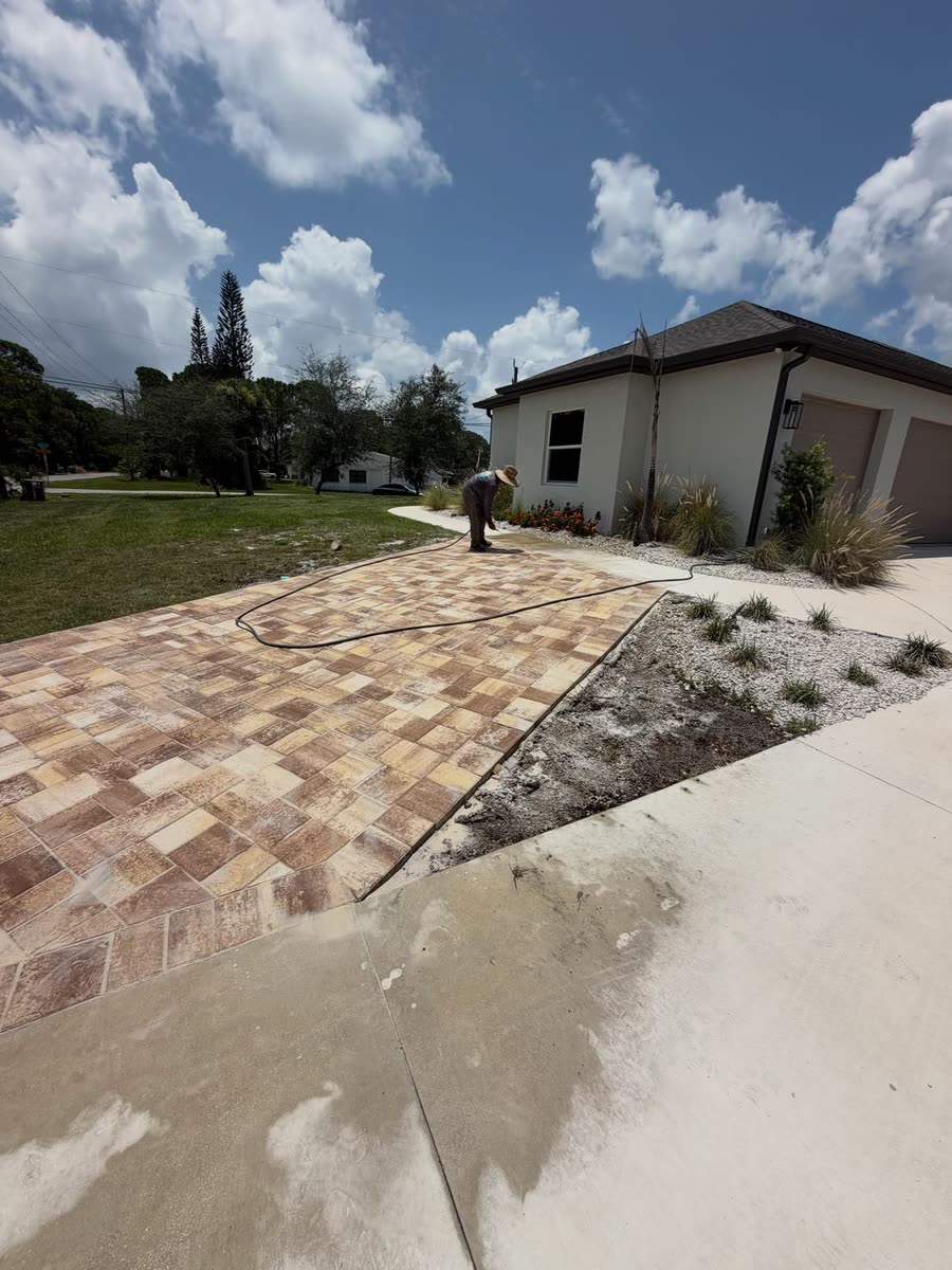 A strip of pavers laid along the side of a concrete driveway to widen it.