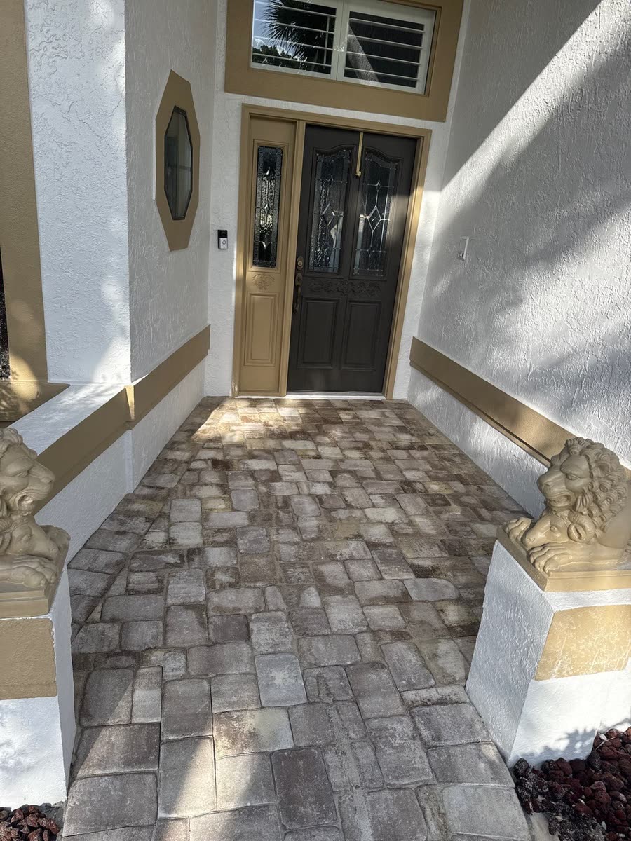 A paver walkway leading up to a front door.